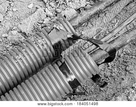 Excavation Of Trench  With Black Cables In Protective Hdpe Tube. Lines Of Metallic And Fiber Optic W