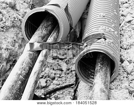 Excavation Of Trench  With Black Cables In Protective Hdpe Tube. Lines Of Metallic And Fiber Optic W