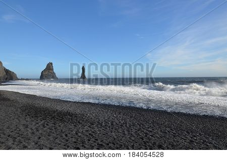 Reynisfjara beach with sea stacks in Southern Iceland.