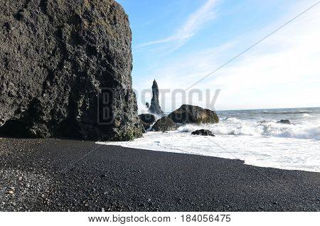 Black sand beach and sea stacks on a perfect day in Iceland.
