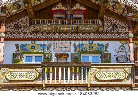 Canazei Italy - April 26 2012: Traditional fully decorated houses in the old village