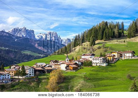 Italy Dolomites the Moena village and in the background tha Catinaccio mountain