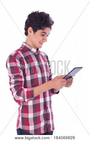 Portrait of smiliy frindly teenage boy holding the tablet and looking to it teenager wearing red shirt isolated white background