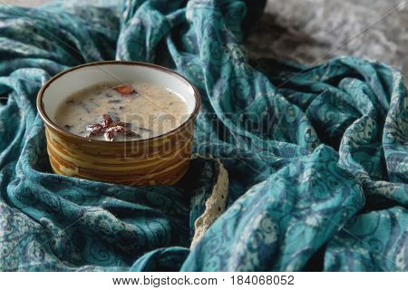 Traditional Indian Masala Tea In Ceramic Cup With Spices To Milk