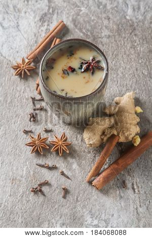 Traditional Indian Masala Tea In Ceramic Cup With Spices To Milk