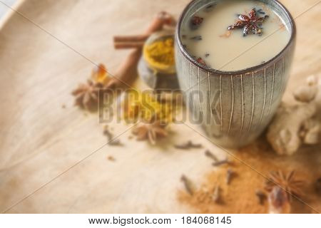Traditional Indian Masala Tea In Ceramic Cup With Spices To Milk
