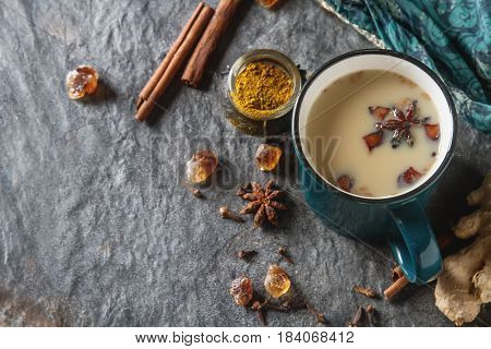 Traditional Indian Masala Tea In Ceramic Cup With Spices To Milk
