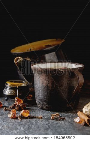 Traditional Indian Masala Tea In Ceramic Cup With Spices To Milk
