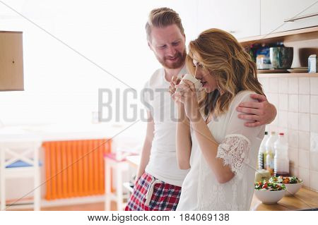 Romantic couple in love speding time together in kitchen