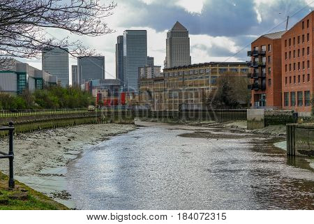 River lea near Bow looking towards Canary Wharf at low tide.