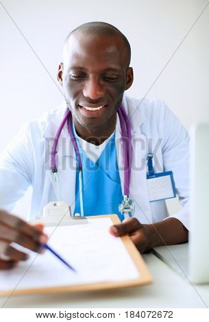 Male doctor sitting at his desk