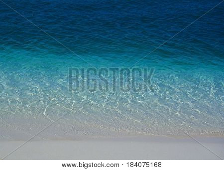 Crystal clear sea over white clean beach sand
