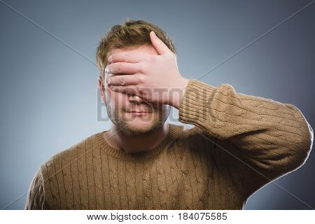 Closeup Scared and shocked man. Studio shot portrait over gray background. Human emotion face expression. Life perception achievement vision.