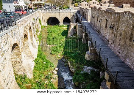 An old quarter with sulfur baths in Tbilisi a view of the shrunken canal. April 17 2015