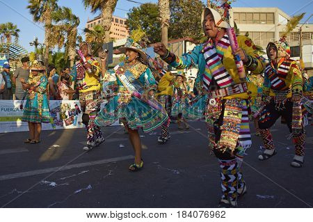 ARICA, CHILE - FEBRUARY 11, 2017: Tinkus Dance Group dressed in ornate costumes performing a traditional dance during a street parade at the annual Carnaval Andino con la Fuerza del Sol.