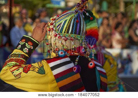 ARICA, CHILE - FEBRUARY 11, 2017: Tinkus Dance Group dressed in ornate costumes performing a traditional dance during a street parade at the annual Carnaval Andino con la Fuerza del Sol.