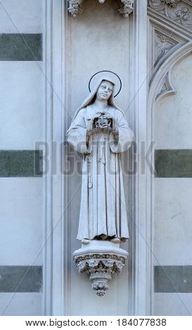ROME, ITALY - SEPTEMBER 02: Statue of St. Catherine of Genoa on the facade of Sacro Cuore del Suffragio church in Rome, Italy  on September 02, 2016.