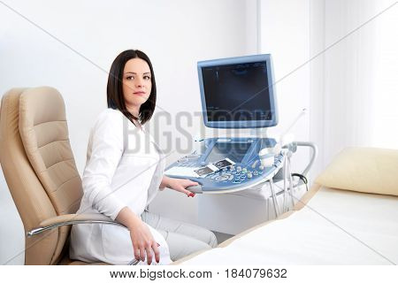Attractive female professional doctor looking to the camera confidently posing at her office copyspace gynecology gynecologist professionalism occupation trustworthy experience sonogram pregnancy.