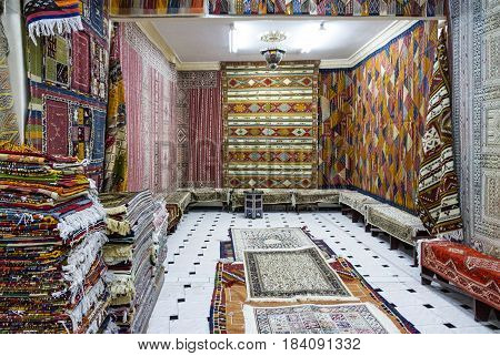 Moroccan carpets in shop room interior, Morocco