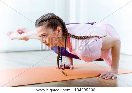 Beautiful Young Woman Practicing Yoga At Home.