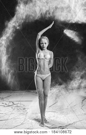 Black and white portrait of young dancer with white flour