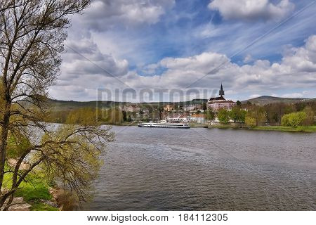 cargo ship moored on river Elbe in spring Litomerice city in Czech republic