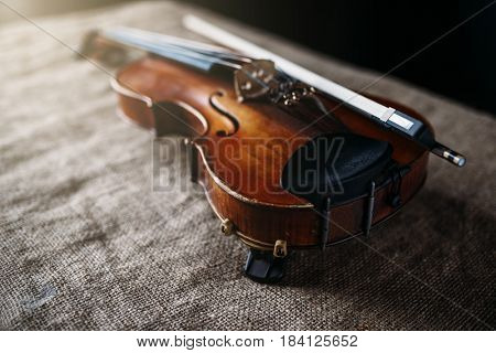 Violin, fiddlestick and bowtie, canvas background