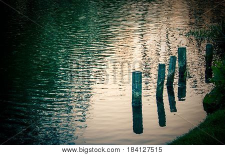 Old boat wooden boat moorings in a twighlight river....