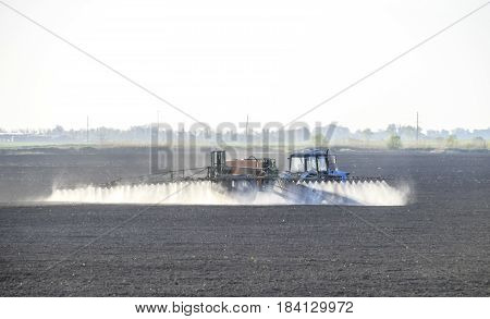 The Tractor Sprayed Herbicides On The Field. Chemistry In Agricu