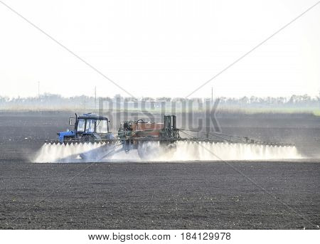 The Tractor Sprayed Herbicides On The Field. Chemistry In Agricu