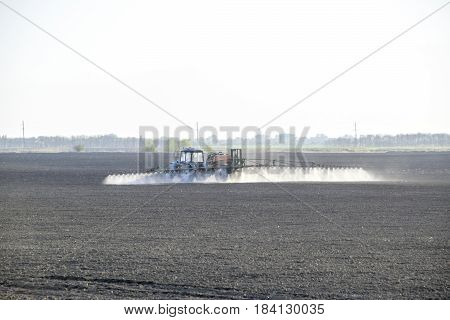 The Tractor Sprayed Herbicides On The Field. Chemistry In Agricu