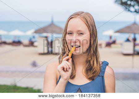 Women Eat Fried Sweet Potatoes In The Park. Junk Food Concept