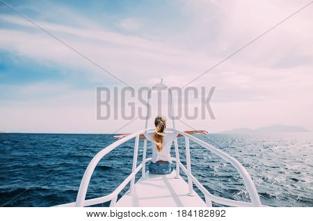 Young Woman In Front Of Nose Of White Yacht With Raised Hands Enjoy The Wind And Sea. Summer Vocatio