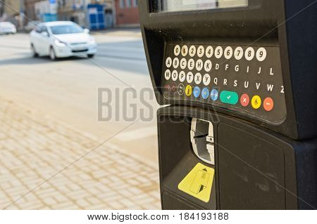 Close up of parking meter with colorful buttons in the street