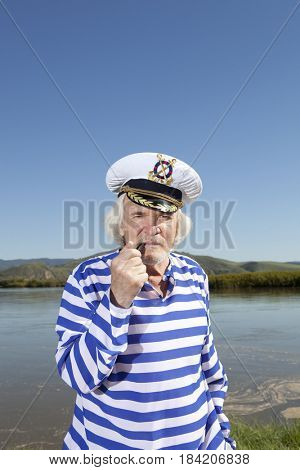 Captain smokes a pipe. Sailor man