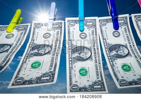 Dollar money in sunshine dollars hanging on the clothes line