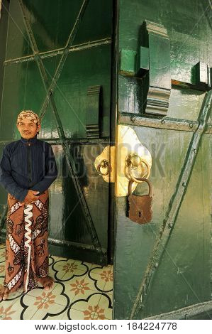 Yogyakarta Indonesia - 28 January 2013: man standing in front of the entrance door of Kraton Palace at Yogyakarta Indonesia