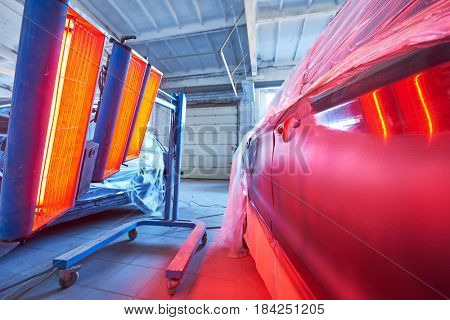 Auto body repair. infrared lamp in use