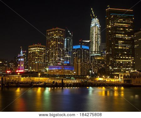 Nighttime view of the beautiful San Francisco skyline with light reflections in the bay