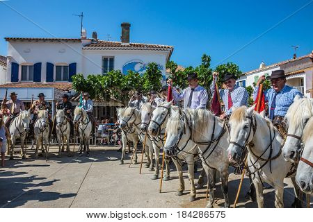 Sent-Mari-de-la-Mer, Provence, France - May 25, 2015. Guards on white horses before the start of the parade. World Festival of Gypsies. The concept of ethnographic tourism