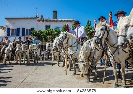 Sent-Mari-de-la-Mer, Provence, France - May 25, 2015. Guards on white horses before the start of the parade. The concept of active and ethnographic tourism. World Festival of Gypsies