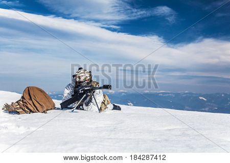 Army soldier with Sniper rifle in action in the Arctic. He lies in the snow desert, suffering from extreme cold, but waiting as long as enemies appear to kill them