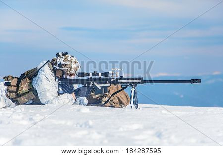 Army soldier with Sniper rifle in action in the Arctic. He lies in the snow desert, suffering from extreme cold, but waiting as long as enemies appear to kill them