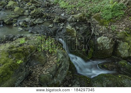 Waterfall near Moravany village in spring green evening