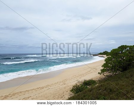 Waves break and crash towards the Hanakailio Beach on the North Shore of Oahu Hawaii.