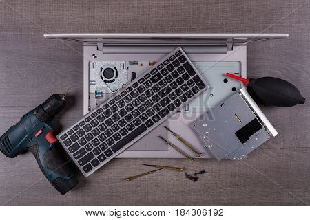 computer notebook with coponent and tool (repair concept) on wood table background