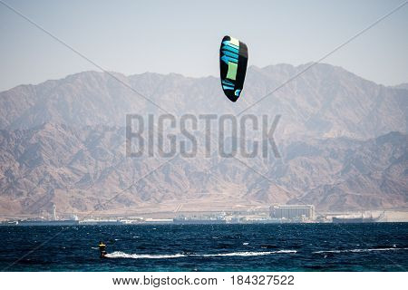 kiter in the surrounding of turquoise sea kiting Israel