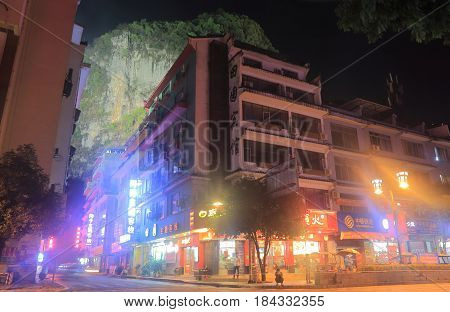 YANGSHOU CHINA - NOVEMBER 19, 2016: Yangshou town night cityscape and karst mountain.