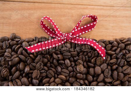 Roasted coffee beans forming shape on wooden background