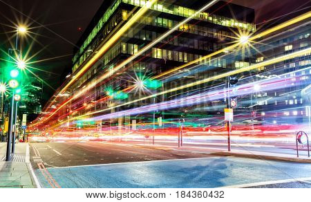 Blur traffic lights in modern city, long exposure. Fast cars created colored lines of light